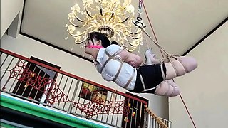 Asian girl bound, gagged and suspended in BDSM session