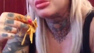 Blonde tattooed milf eats spaghetti on the toilet