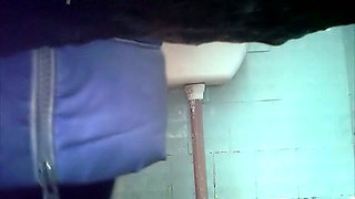 White amateur chick in coat filmed on cam in the toilet