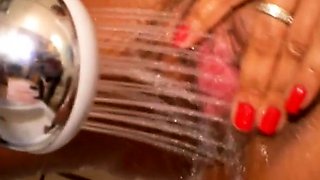 Mulatto woman pissing with big breasts while showering