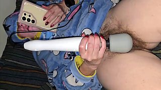 Horny bitch watches porn and fingering her cunt. With the help of magic wand gets an orgasm