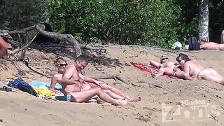 Blowjob on a nudist beach.