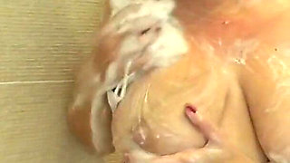 Camilla scrubs up in the shower